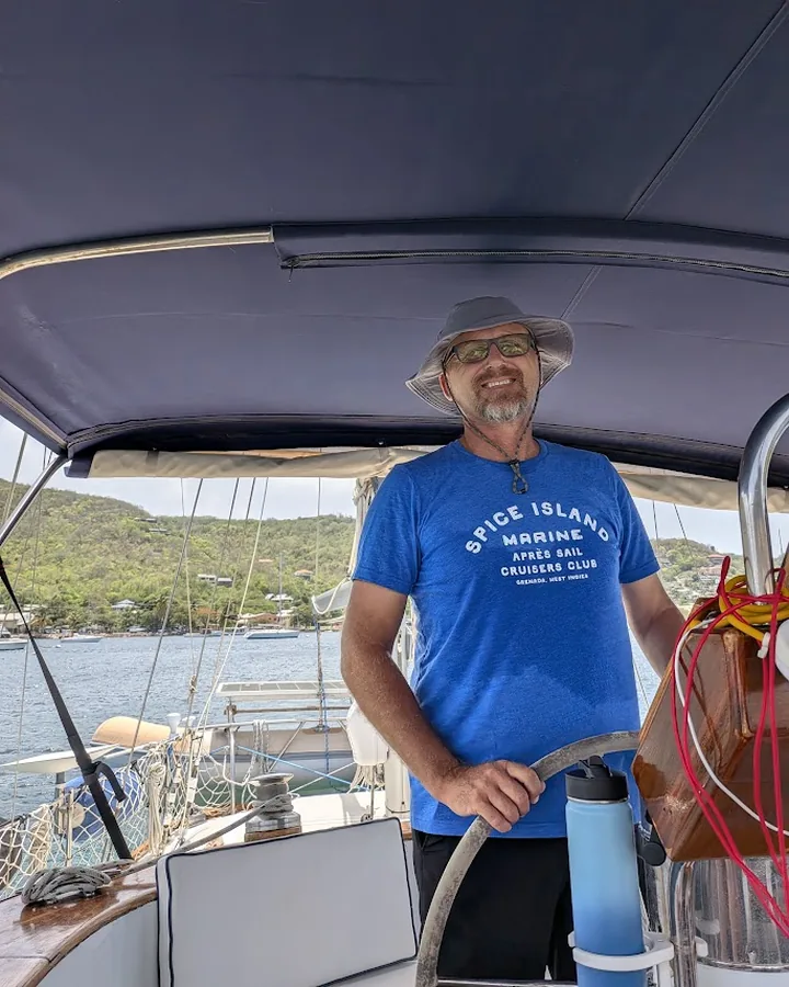 Vessel Ready founder and Master Mariner Dwayne Miner at the helm of his sailing vessel