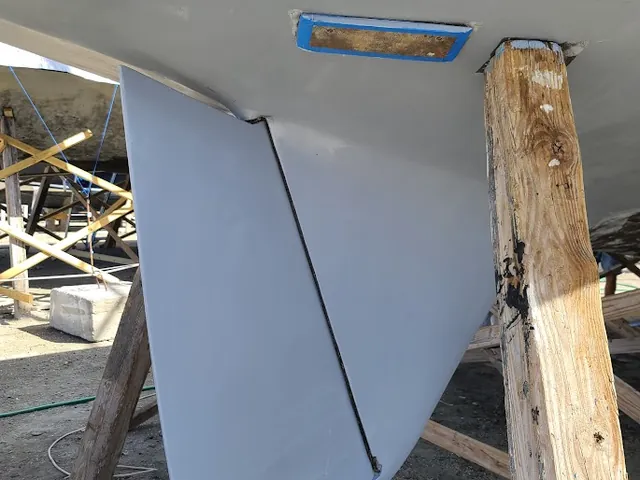 Sailboat rudder and underwater hull inspected ashore during a haul-out