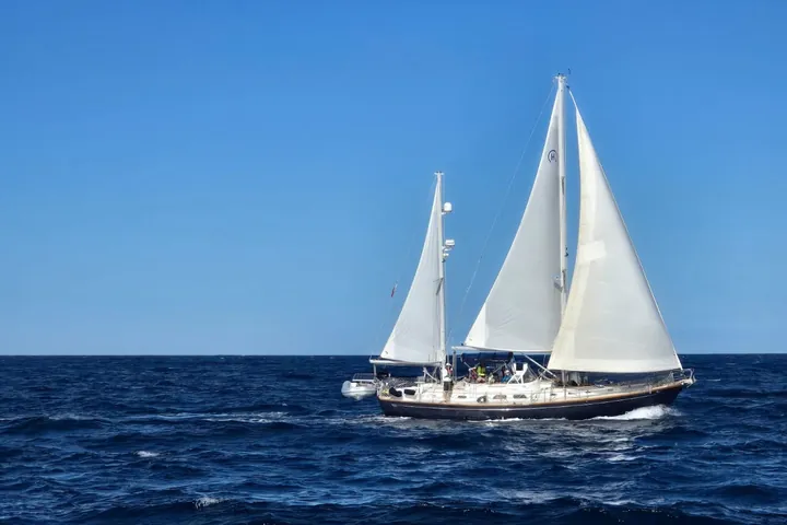 Cruising sailboat under full sail on open water