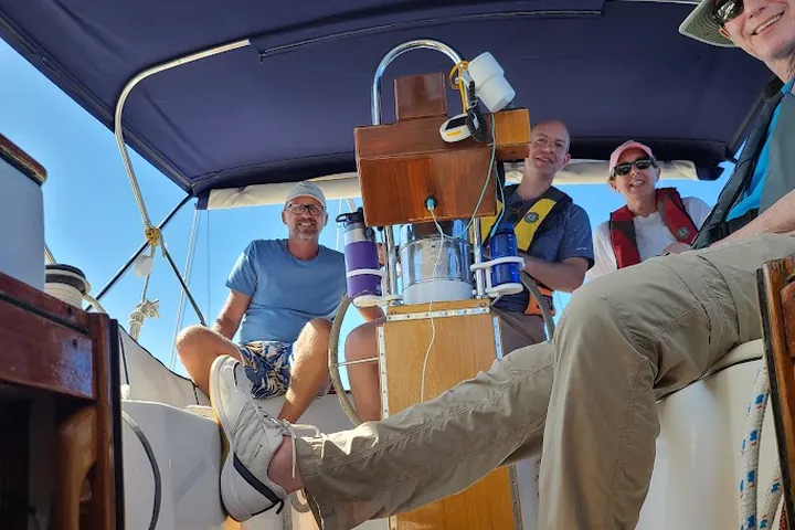 Crew and students aboard a sailing vessel during an on-water session